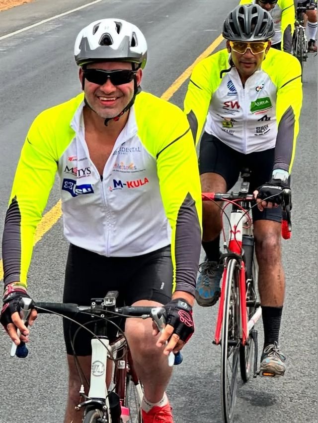 Two riders smiling on a road ride