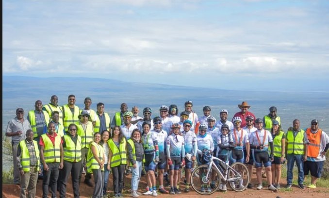 Riders and support crew at a Rift Valley viewpoint